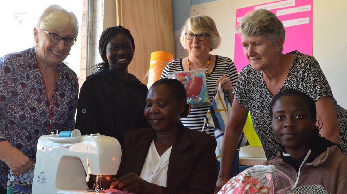 HELPING HANDS: Sue Knight, Nashwa Bakini, Niemat Darar, Kath Corio, Gill Hindmarsh and Gloria Angollo volunteering at Kenna Hall to create items to send to Sudan. Photo: DAVID FITZSIMONS