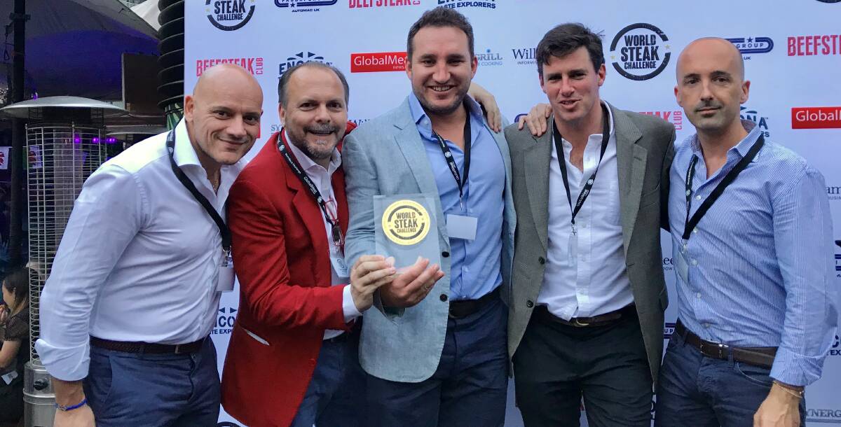 GOLDEN: Cousins Sam McNiven (centre) and James Millner (second from right) with European clients and their World Steak Challenge gold medal. Photo: Supplied