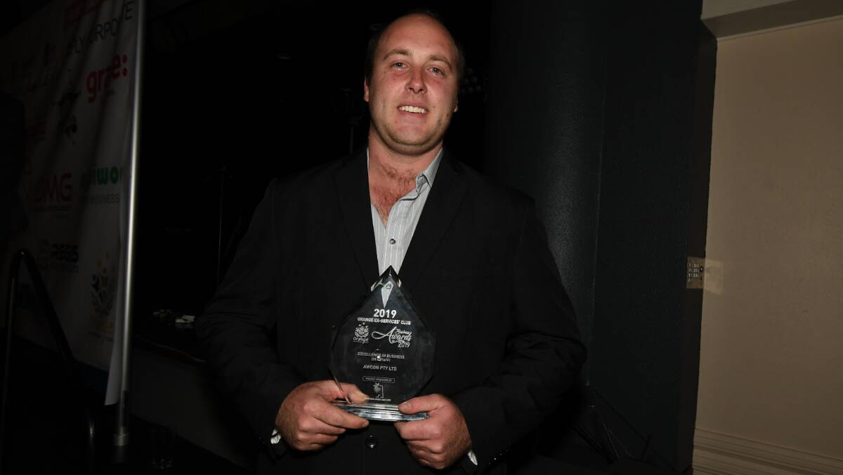 SUCCESSFUL: Andrew Ison with the award for Excellence in Business (20-plus staff) won by AWCON. Photo: JUDE KEOGH 0706jkbusiness16