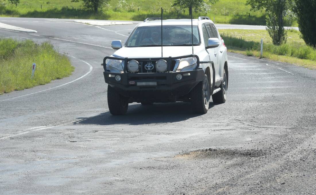 BUMPY RIDE: A car on Dairy Creek road near the Mitchell Highway which will be rebuilt as the Southern Feeder Road. Photo: CARLA FREEDMAN