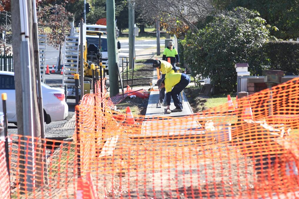 PLENTY OF WORK: A crew constructs a footpath in Prince Street on Thursday. Photo: JUDE KEOGH