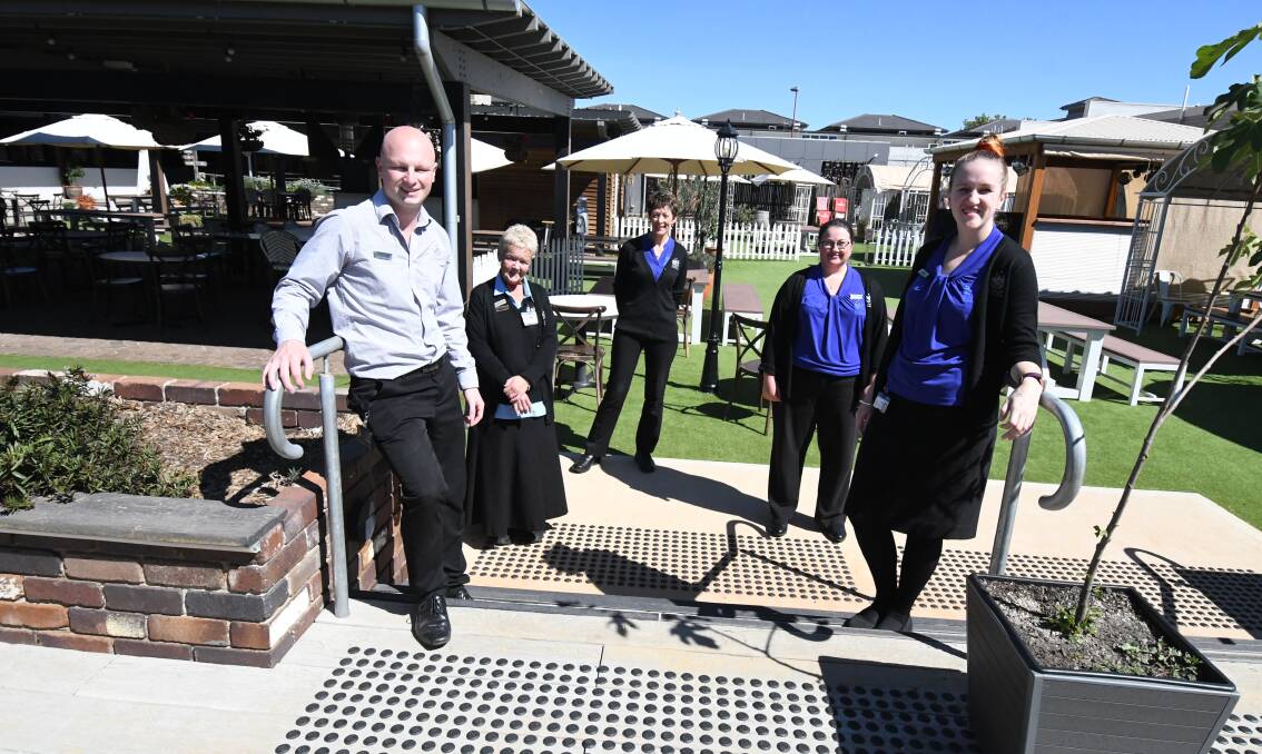 TOUGH TIMES: Staff Michael Rudd, Robyn Morgan, Kerrie Irwin, Jessica Coster and Kasie Ballard at the Ex-Services' Club's rooftop Greenhouse area. Photo: JUDE KEOGH