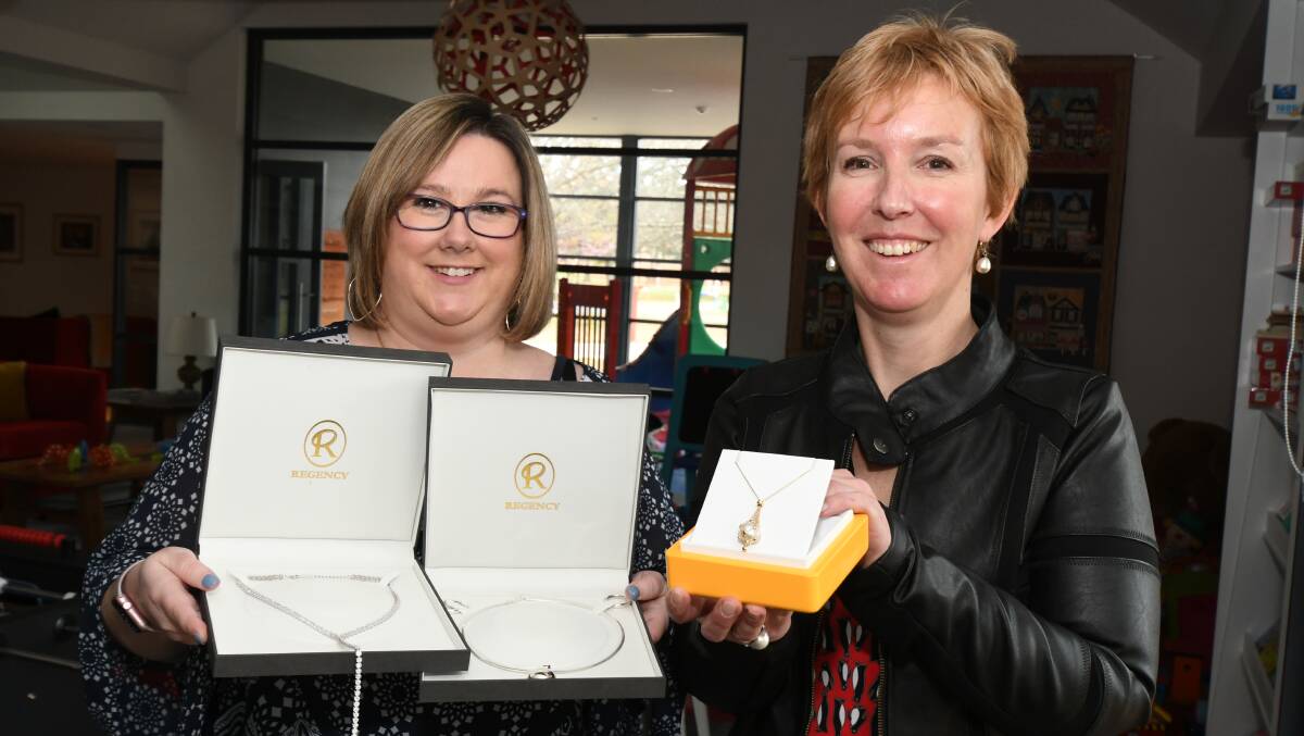 JEWELS IN THE CROWN: Kellie Hughes and Rebecca Walsh show off some of the raffle prizes. Photo: JUDE KEOGH 0904ronald3