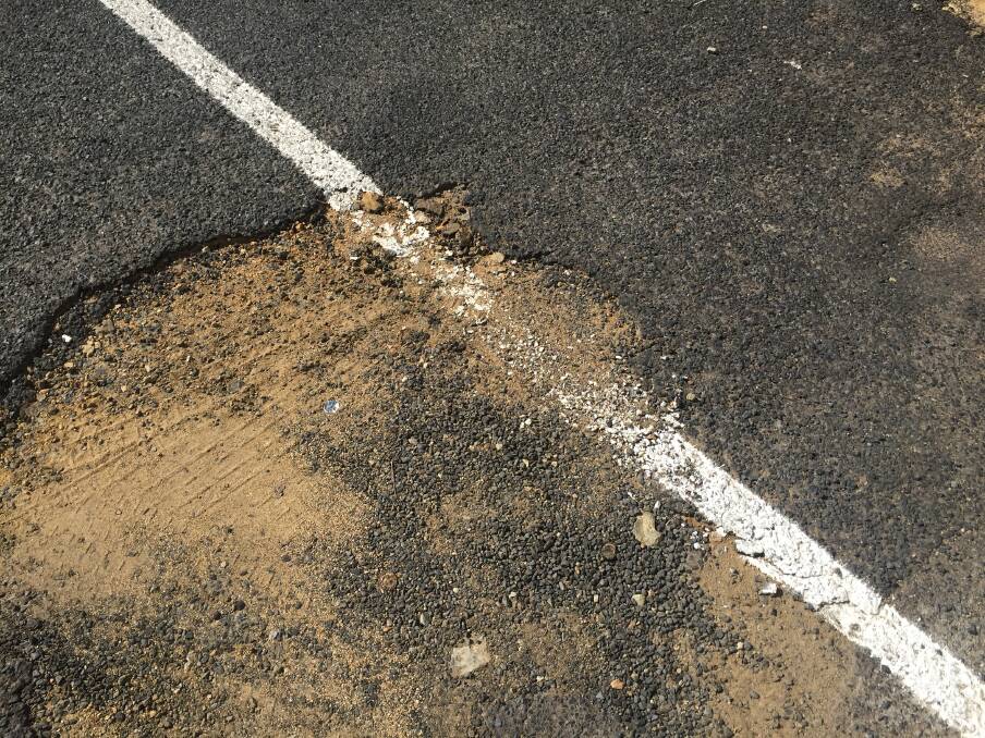 REPAIR NEEDED: Paint in a pothole in the car park.