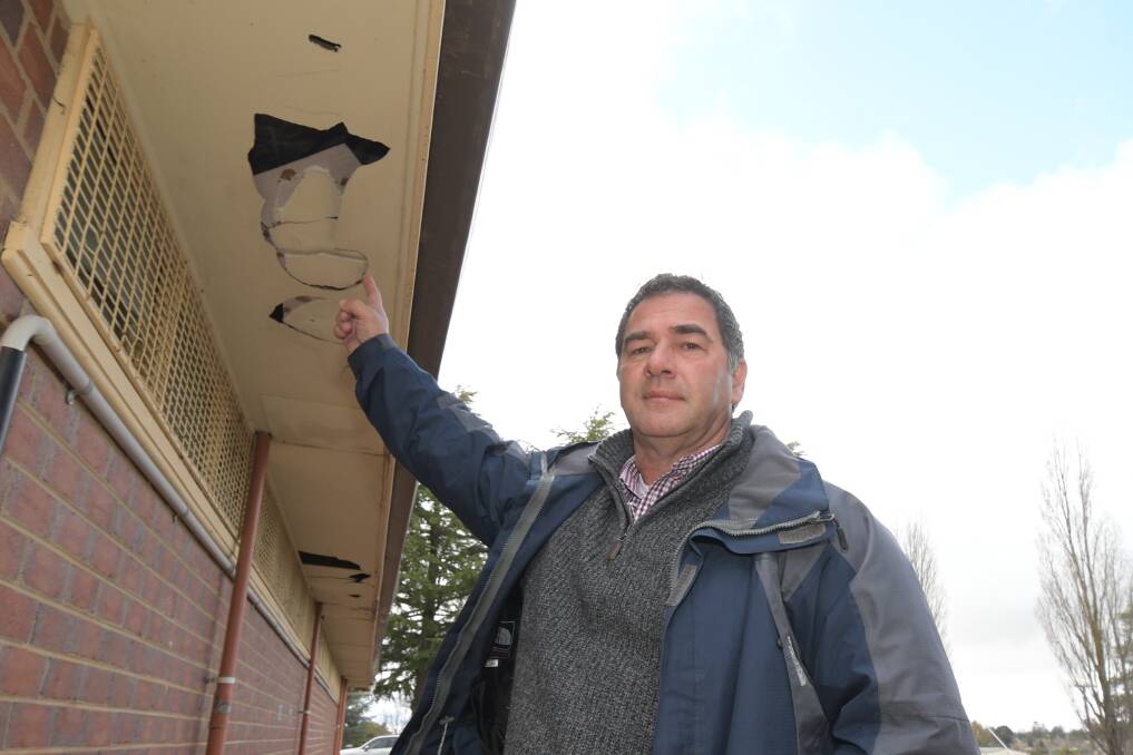 DAMAGE: Cr Tony Mileto highlights asbestos found in broken eaves at a building at Jack Brabham Park. Photo: JUDE KEOGH