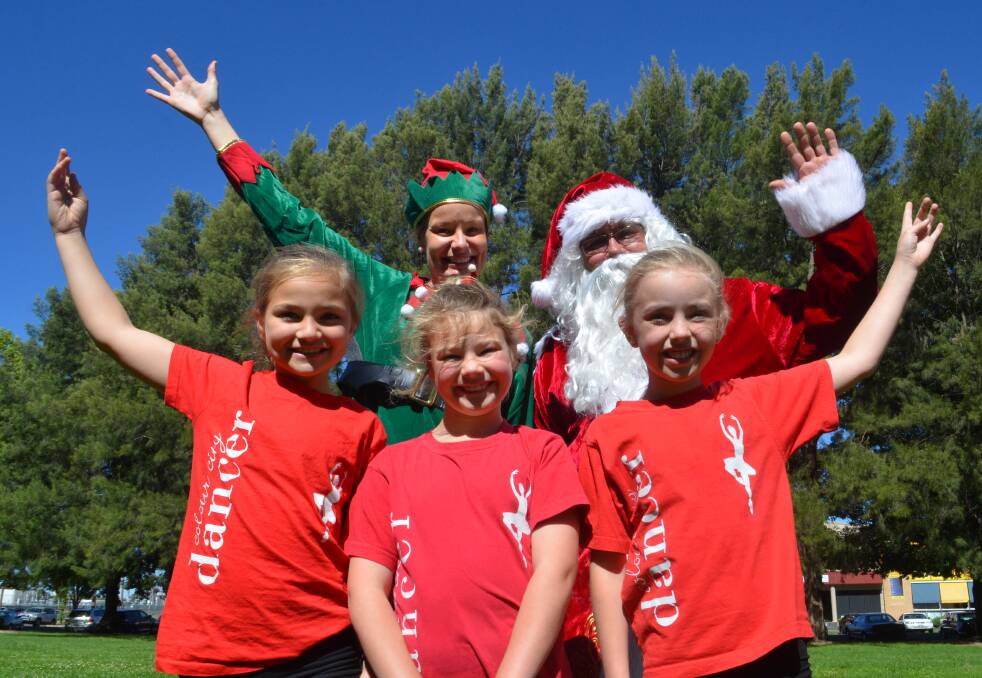 READY FOR THE BIG NIGHT: Colour City dancers Brianna Elliott, Jacqui Whittaker and Ella Priest joined Santa and one of his elves at the Northcourt this week to let everyone know Carols by Candlelight was on this week. Photo: DAVID FITZSIMONS 1203dfsanta5