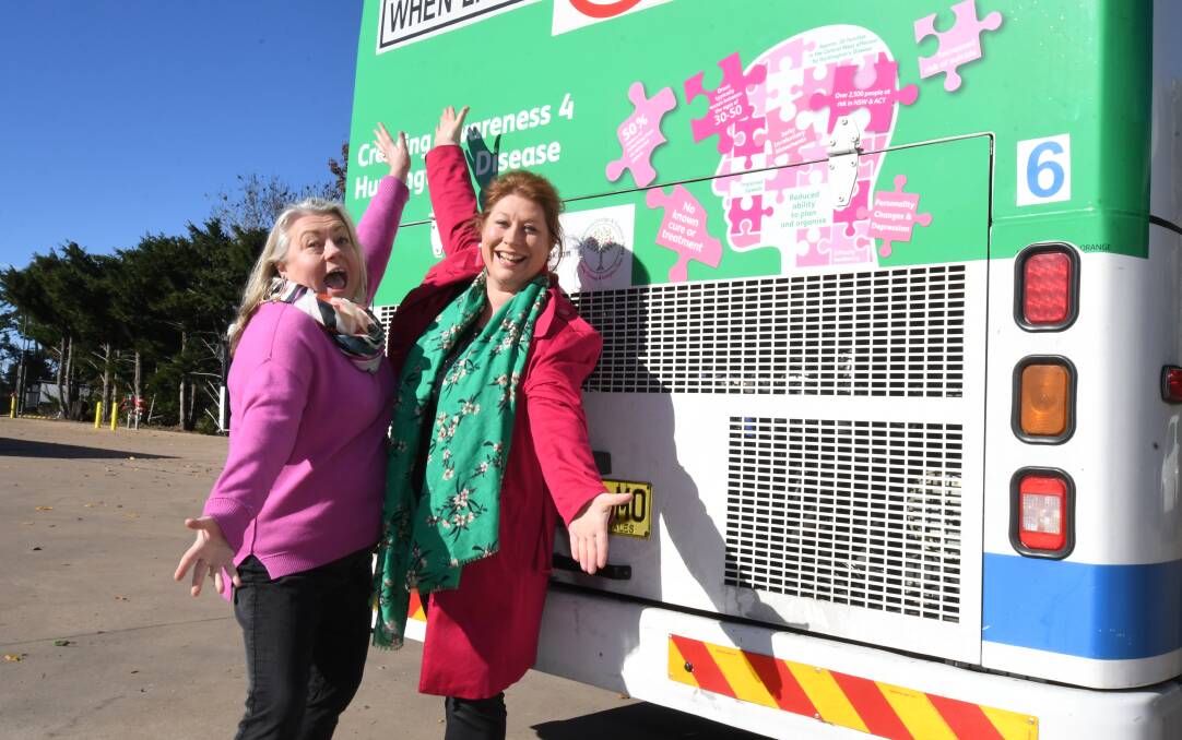 ON THE BUS: Tash Rossiter and Rachael Brooking show off the Huntington's Disease awareness promotion on the back of an Orange bus. Photo: JUDE KEOGH