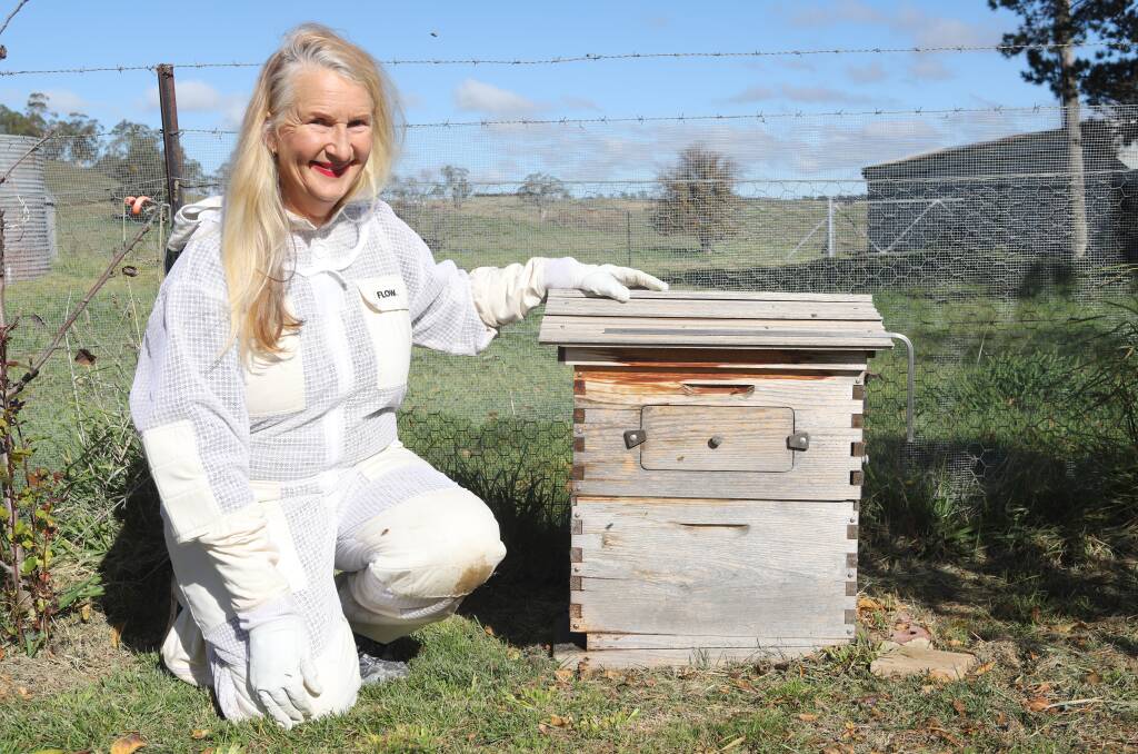 WHAT'S THE BUZZ: Amateur beekeeper Gillian Serisier with a hive in her vegetable garden. Photo: CARLA FREEDMAN