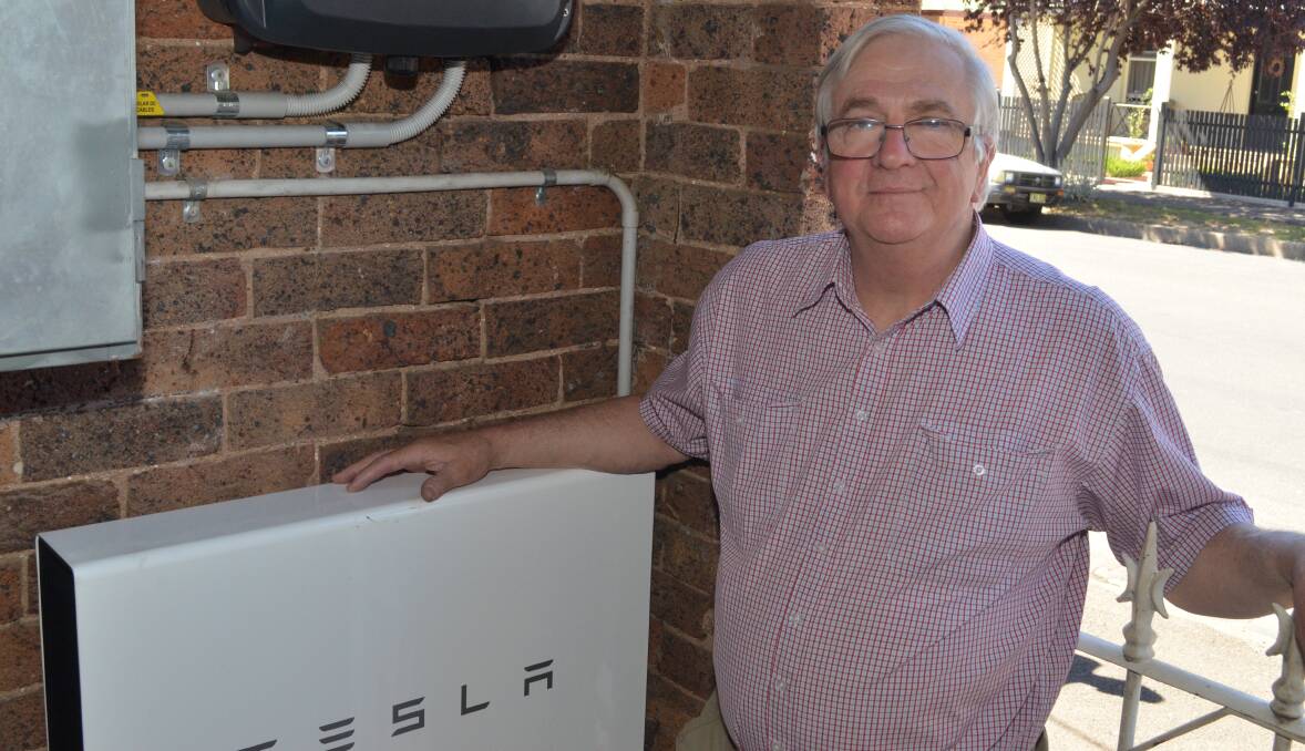FORWARD THINKING: East Orange post officer owner Conrad Silvester shows off his new Tesla storage battery installed in the 1888 building. Photo: DAVID FITZSIMONS 0119dfeast4