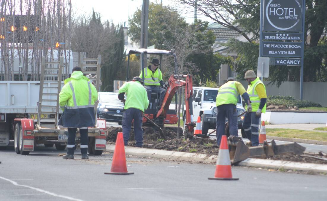 TREE RE-PLANTING: Orange City Council staff at work in Woodward Street on Tuesday. Photo: JUDE KEOGH