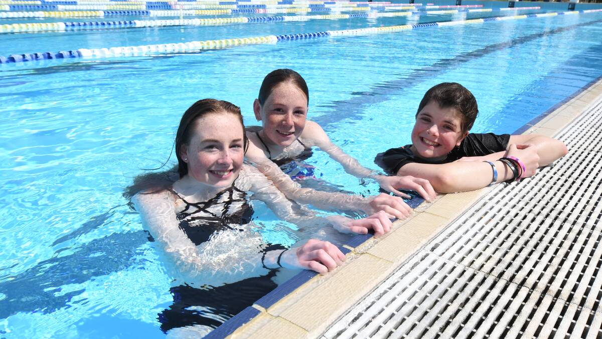 TAKING A DIP: Savannah and Dakoda Trainor and Jenae Ostini were in the outdoor pool on Monday. Photo: JUDE KEOGH 0930jkpool1
