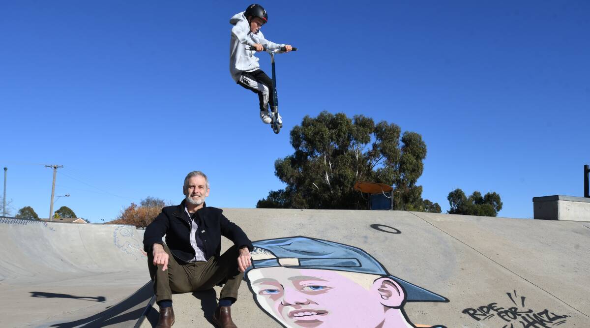 FLYING HIGH: Cr Stephen Nugent shows off the art at the skate park as Nick Stedman shows off his scooter skills. Photo: CARLA FREEDMAN