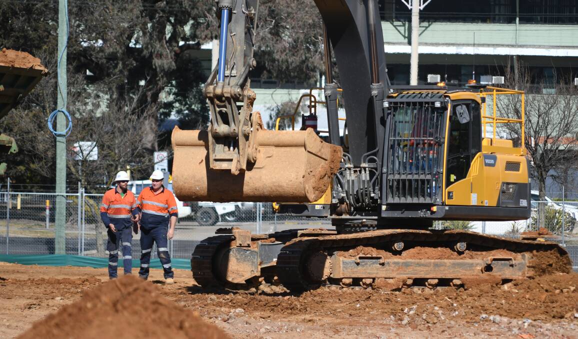 CLEANING UP: Workers were busy removing piles of dirt from the old hospital site on Friday ahead of construction work starting for the new DPI building. Photo: JUDE KEOGH 0727jkhosp3