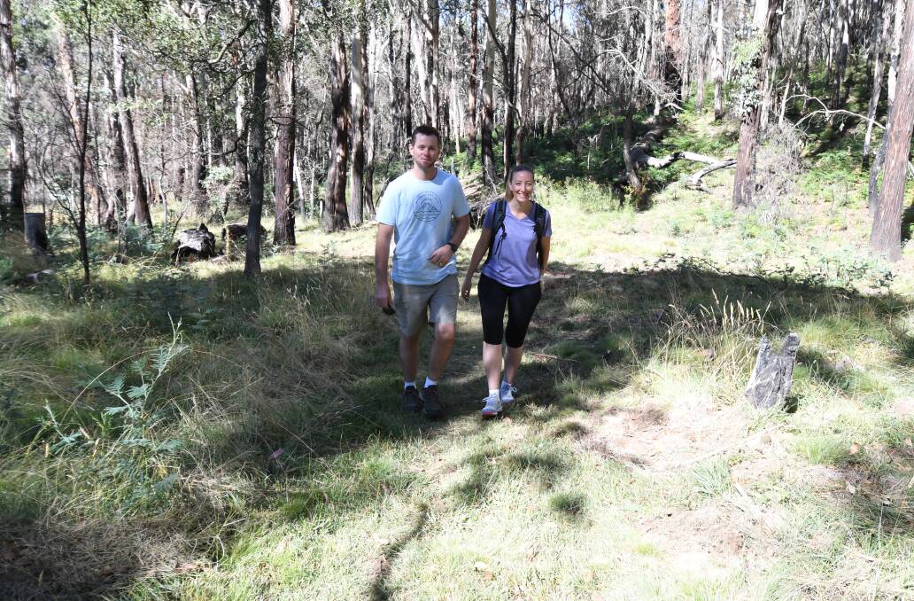 OPENING WEEKEND: Mick and Kelly Jenkins from
Sydney taking the bushwalk to Federal Falls on Sunday.
Photo: CARLA FREEDMAN 0310cfmtcanobolas5