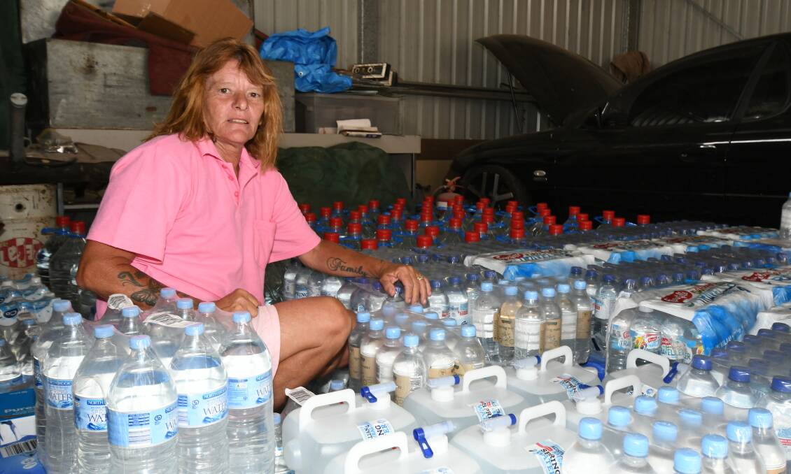 GIFTS: Maree Glohe with some of the water donated by people in Orange. She will be taking it to Walgett on Tuesday to help ease town's water shortage. Photo: CARLA FREEDMAN 0106cfdrought3