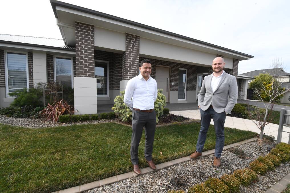 HIGH PRICE: Real estate agents Adam Scimone and Tom Figuero at the Stirling Avenue house. Photo: JUDE KEOGH