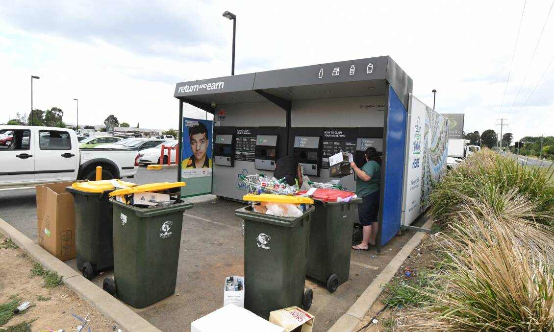 OVERFLOWING: Bins are full of rubbish as people load plenty of cans and bottles into the Return and Earn machine at North Orange. Photo: CARLA FREEDMAN 1231cfrecycle1