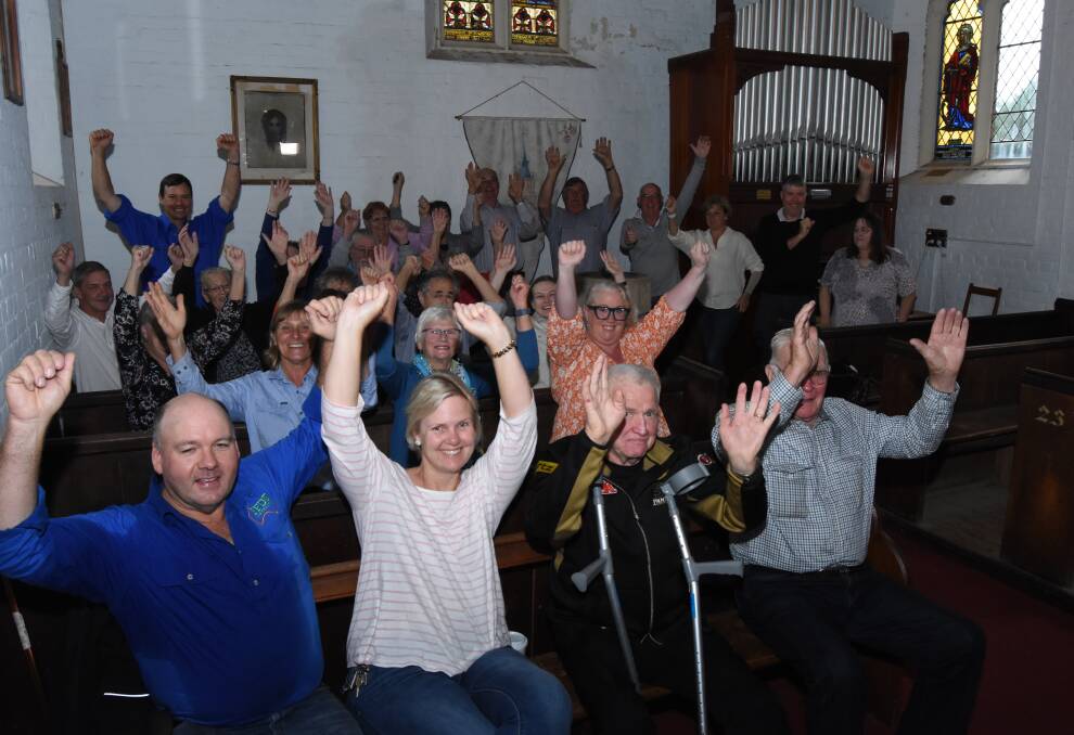 HOORAY: Supporters of saving St Paul's Anglican Church in Carcoar celebrate on hearing the news that the money needed has been raised: Photo: Mark Logan. 