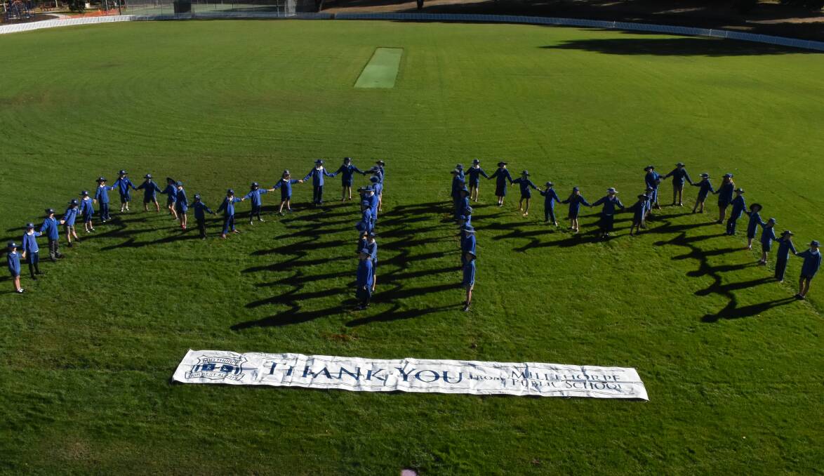 Big thanks: Millthorpe Public School students formed a big MM on Redmond Oval. Photo: MARK LOGAN. 