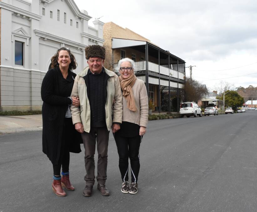 RUGGED UP: Orange 360's Caddie Marshall with Millthorpe's Sam Yeates and Mary Dowrick Debere at Millthorpe's Pym Street, where the food and wine market will be held. Photo: MARK LOGAN