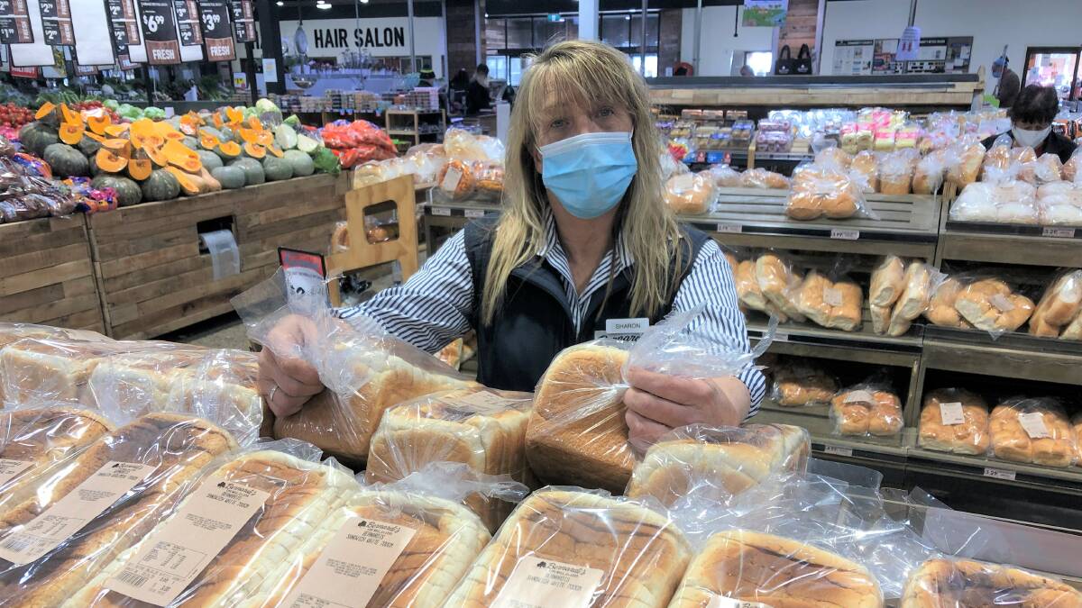 STOCKING UP: Payroll Officer Sharon Kinghorne helping out in the bakery section of Bernardi's supermarket in Blayney. Photo: Mark Logan.