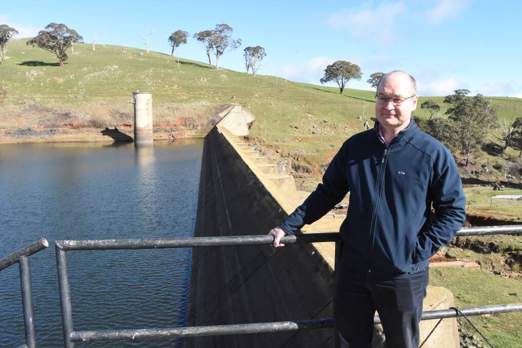 BUILD THE WALL: CTW general manager Gavin Rhodes at the Lake Rowlands dam wall that shows at the far end of the wall how high it can be extended. Photo: MARK LOGAN
