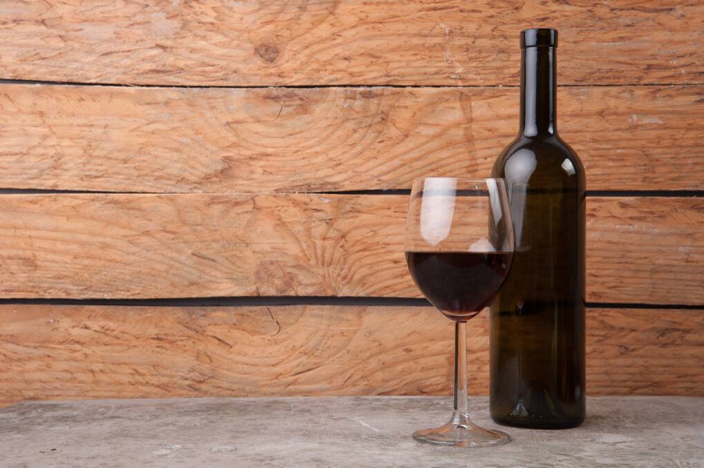 A generic photo of red wine in a glass with a bottle. Picture is from file
