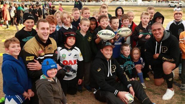 Spreading the word: Penrith players Isaah Yeo, Matt Moylan and Leilani Latu (far right) with children at a recent coaching clinic at Bathurst. Photo: Penrith Panthers