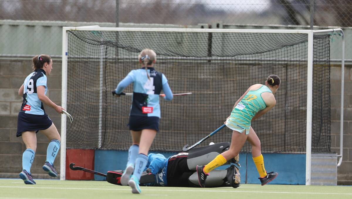 ON TARGET: Orange CYMS' Heidi Zwiers steers the ball over Souths goalkeeper Steph Hinds into the goal. Photo: PHIL BLATCH