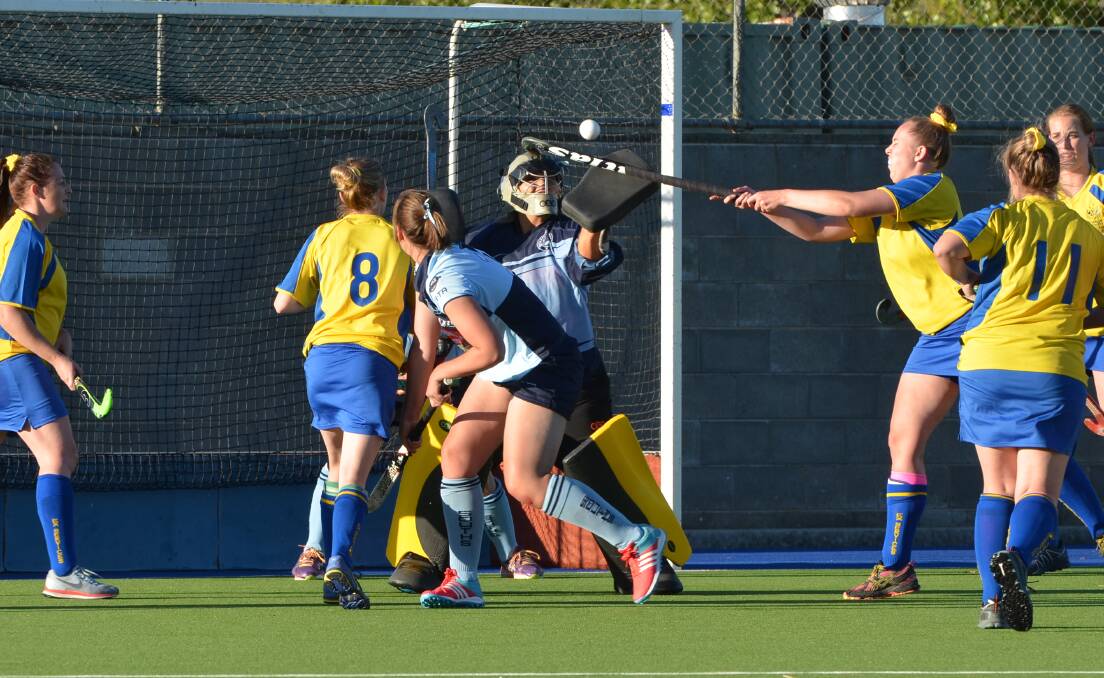 DENIED: Souths goalkeeper Kate Brown gets her glove to the ball as Ex-Services pressure off a penalty corner. Photo: ANYA WHITELAW