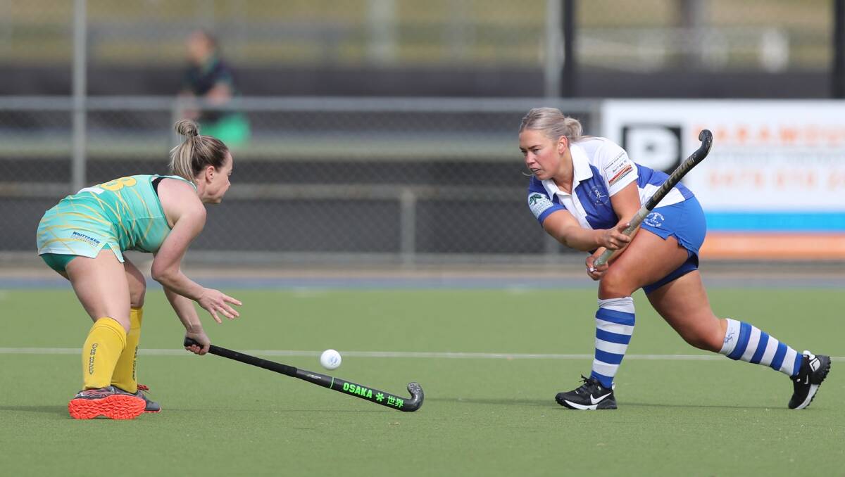 CLEARANCE: Maddy Boyce steers the ball past the stick of Orange CYMS rival Nic Chapman. Photo: PHIL BLATCH