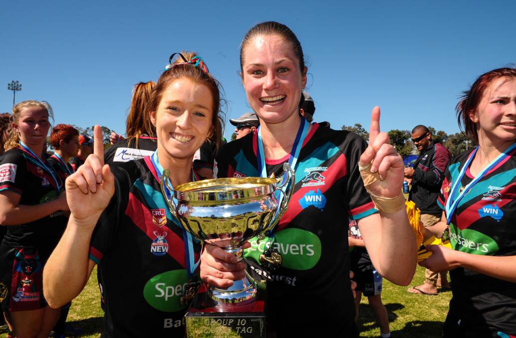 Panthers duo Jess Hotham and Monique Christie-Johnson hold the Group 10 league premiership trophy in 2014. It remains unclear if there will be Group 10 or instead a Western-wide competition for senior league tag sides in 2023.