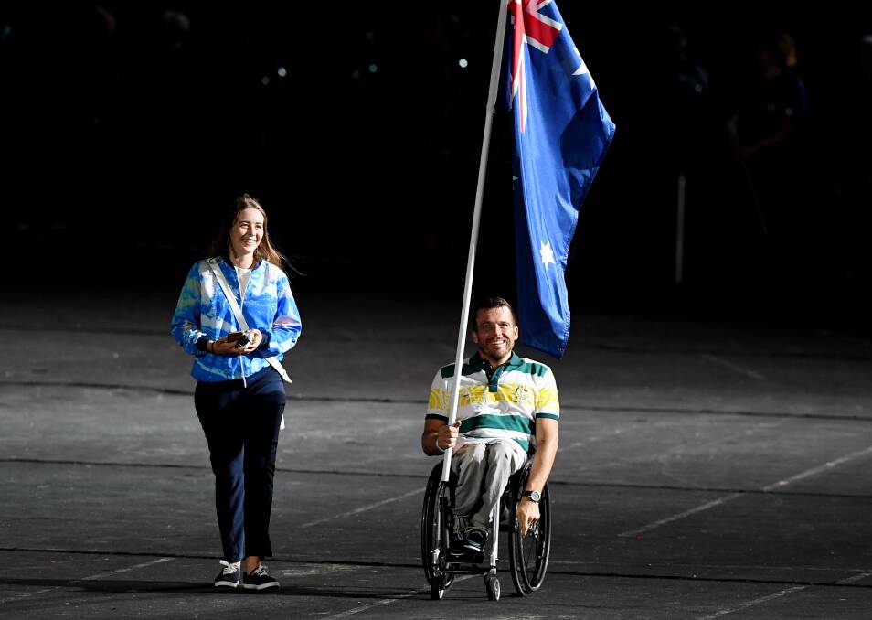 PROUD MOMENT: Kurt Fearnely became the first Para athlete to carry the national flag at a Commonwealth Games closing ceremony on Sunday night. Photo: AAP