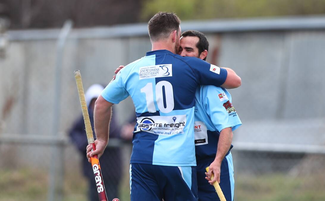 JOB DONE: Jono Cole hugs Keiran Gentles after combining for a goal. Photo: PHIL BLATCH