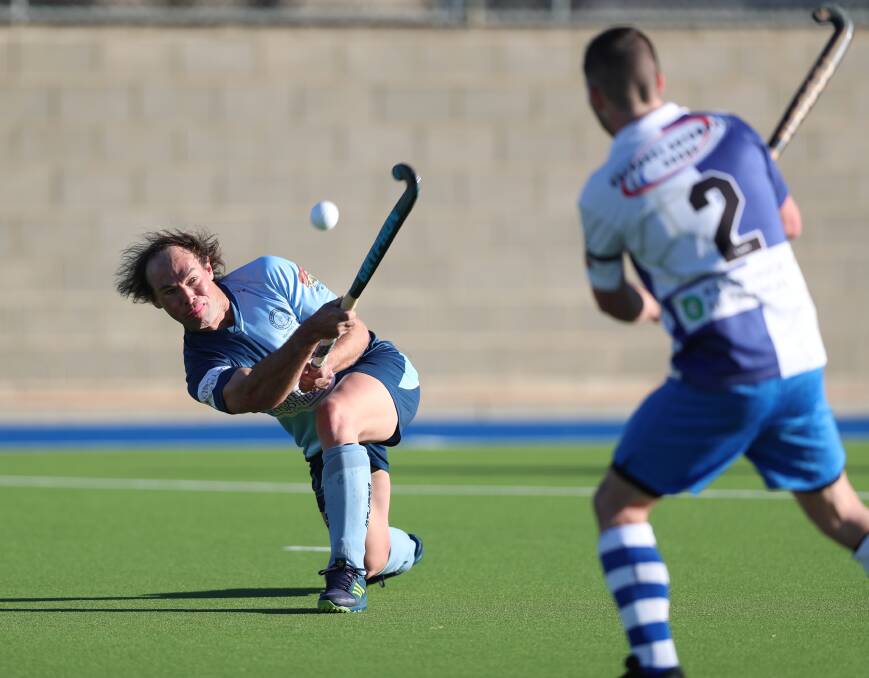 GOING UP: Souths defender Dylan Smith throws an overhead ball in Saturday's Bathurst derby against St Pat's. Souths won the men's Premier League Hockey contest 3-2. Photo: PHIL BLATCH