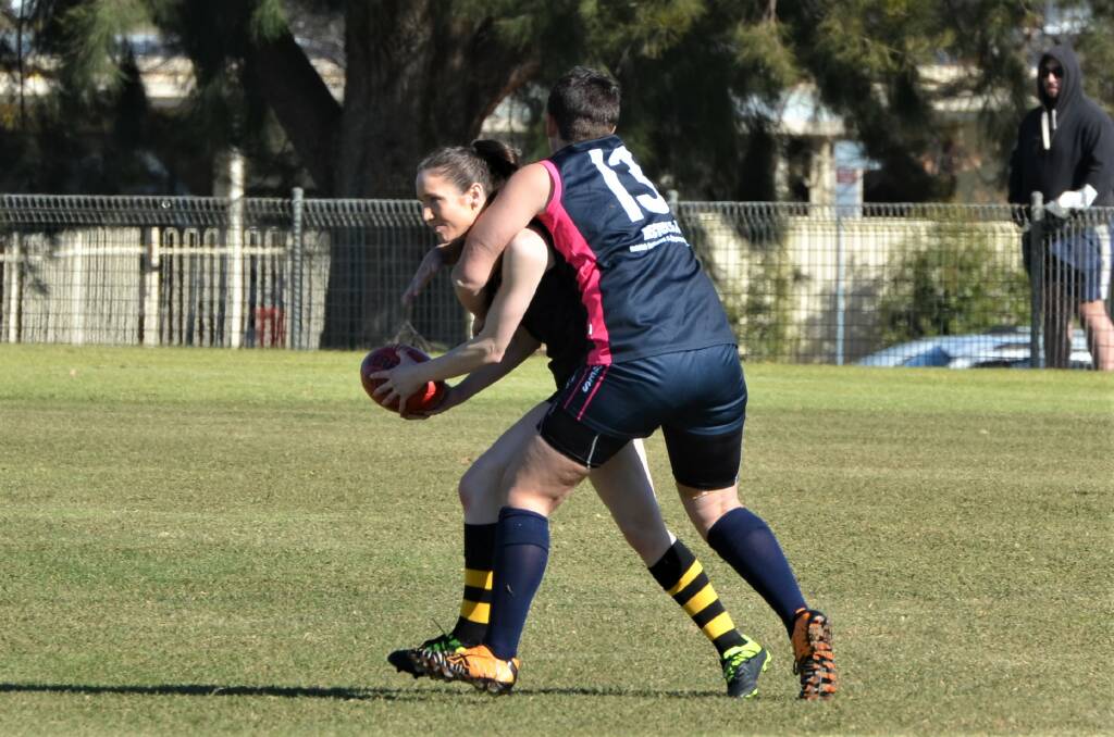 TOUGH CONTEST: Amanda Cass, pictured earlier in the year tackling Charis McKarrell, was solid in the ruck for Cowra, but it wasn't enough, with the Blues losing to Orange. Photo: ANYA WHITELAW