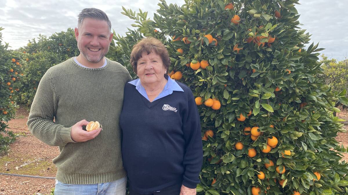 RIPE FOR THE PICKING: Richard Learmonth with Ruth Crompton at the Canodobolin-based orchard. Photo: CONTRIBUTED