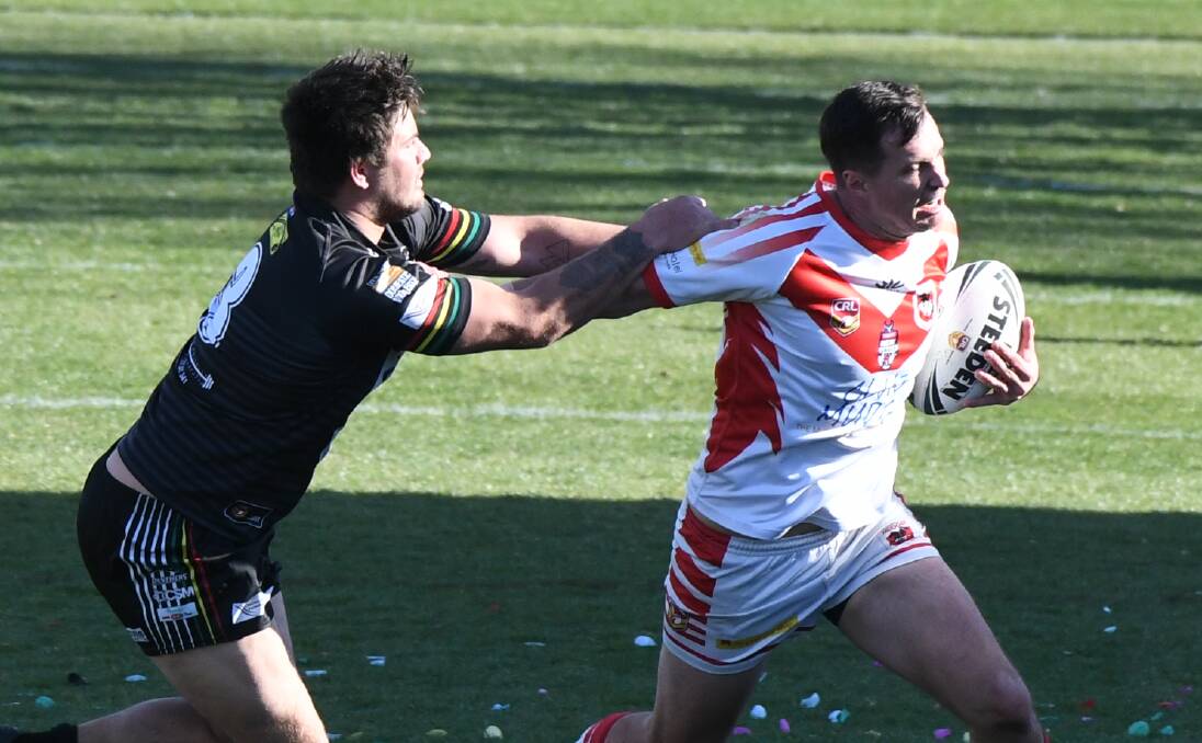 COME BACK HERE: Blake Lawson wrangles Jack Littlejohn at Carrington Park in the 2019 grand final, won 9-8 by Panthers in extra-time. 