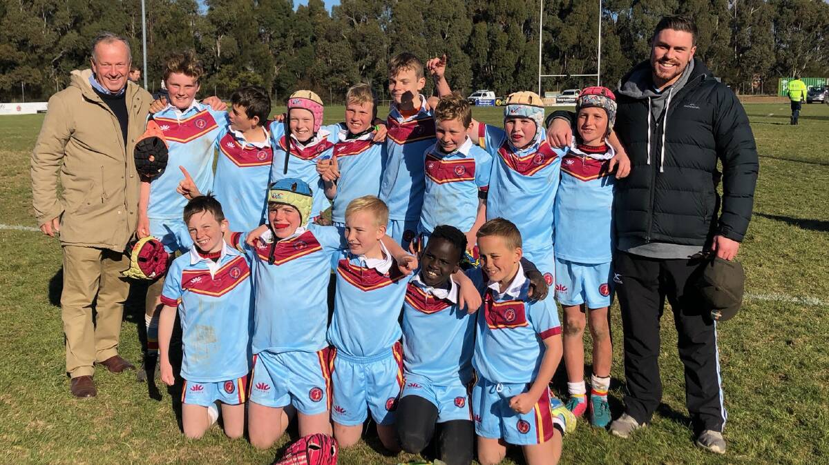 SYDNEY BOUND: The Catherine McAuley rugby union side (from left, back) George Tancred, Seth Vardenaga, Knox Gibson, Jackson Rodwell, Baxter Cook, Bailey Gardiner, Caiden Hoy, Taj Jordan, (left, front) Riley Baird, Tomma Tancred, Drew Scott, Akol Akon and Chayse King pictured with Michael Croke (left) and Robbie Mortimer (right). Photo: CONTRIBUTED