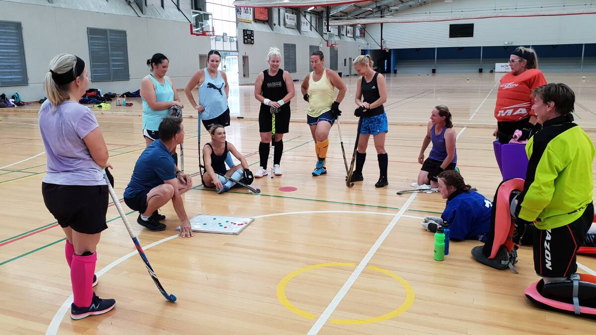 THIS IS HOW IT'S DONE: David Mike goes over some drills with his over 40s indoor side ahead of their World Cup campaign in Hong Kong in February. Photo: CONTRIBUTED
