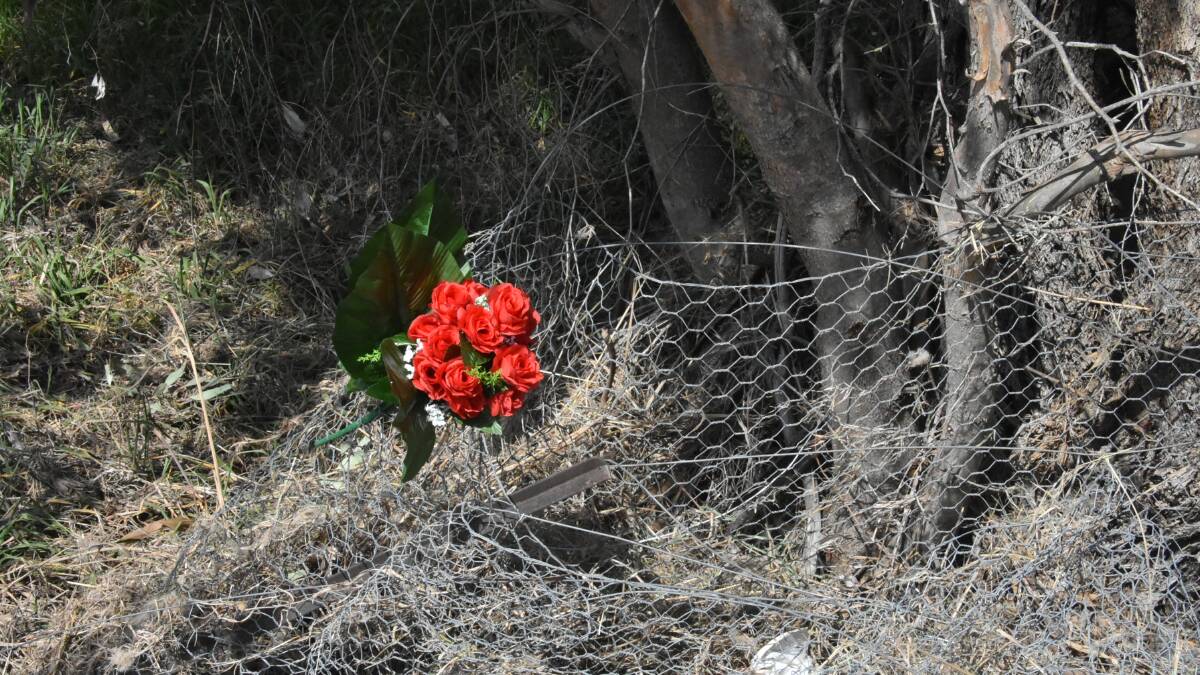 EMOTIONAL TIME: A floral tribute at the scene of Sunday's tragedy where a Cowra High School student was killed. 