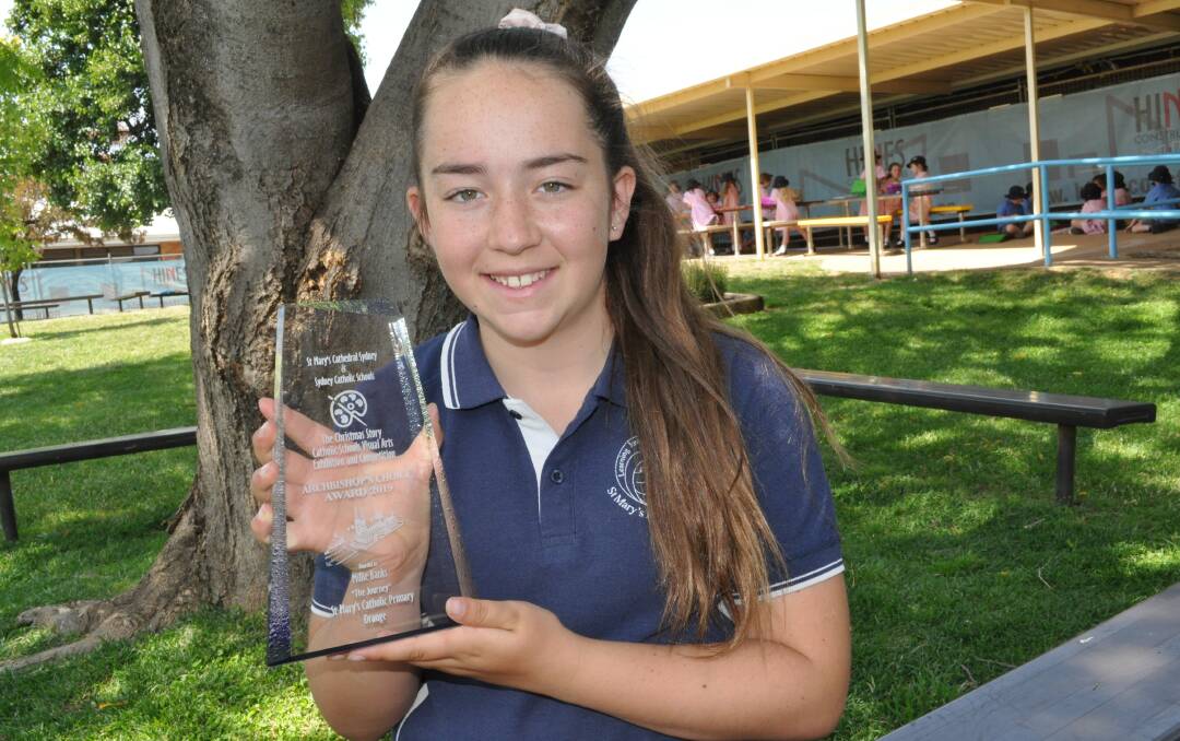 AWARD WINNER: St Mary's Catholic Primary School student Millie Banks with her Archbishop's Choice Trophy. Photo: NICK McGRATH