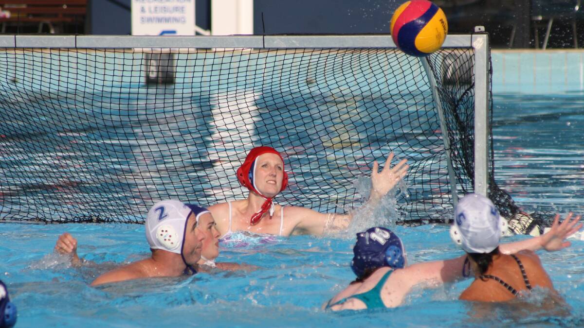 EYES ON THE BALL: Squids goalkeeper Bek Pierce readies to make a save against Flounders. Photo: MICHELLE COOK 1210mcwpolo2