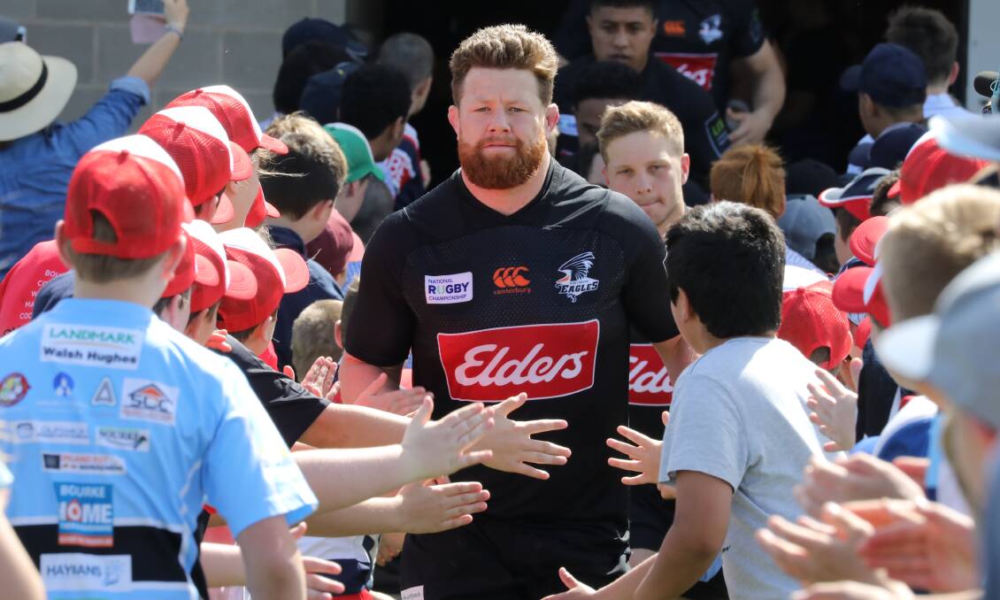 RUNNING OUT: NSW Country Eagles skipper Paddy Ryan leads out his side at Glen Willow on Saturday, with a throng of young Mudgee and Central West players on deck to cheer them out. Photo: SIMONE KURTZ
