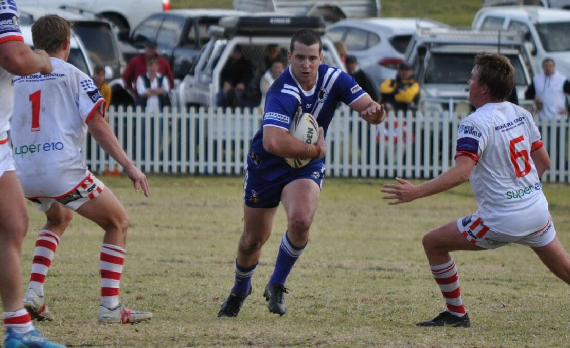 SLICING THROUGH: Molong's Jye Barrow spots a gap in the Manildra line during last year's derby at the Molong Rec. Photo: NICK McGRATH