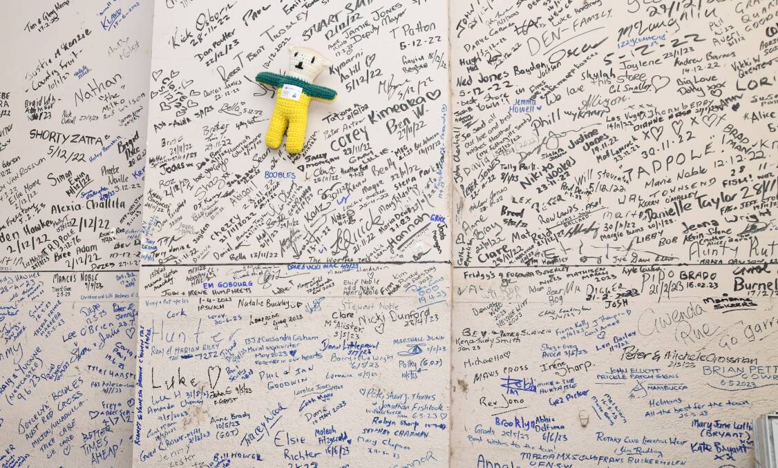 The wall at Danny Townsend's store in Eugowra, where visitors have signed after the floods in November, 2022. Picture by Jude Keogh