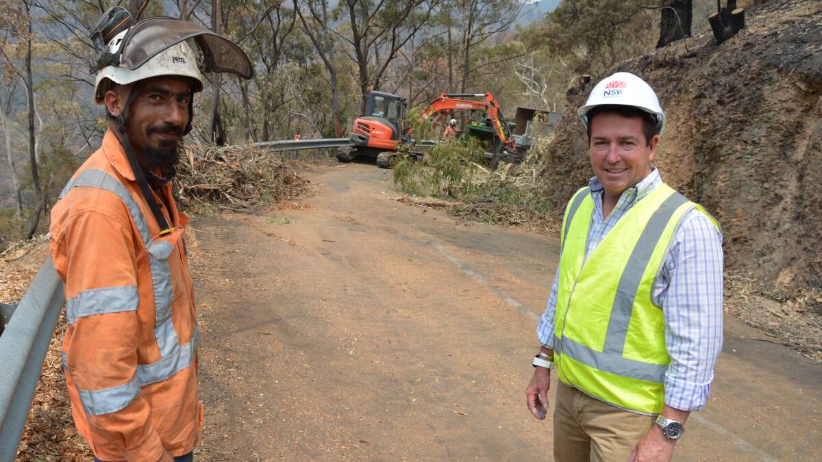 CLEAN-UP: Steve Sarkis from OS Trees and Bathurst MP Paul Toole at
Jenolan Caves Road where the big clean up continues following the recent
bushfires.