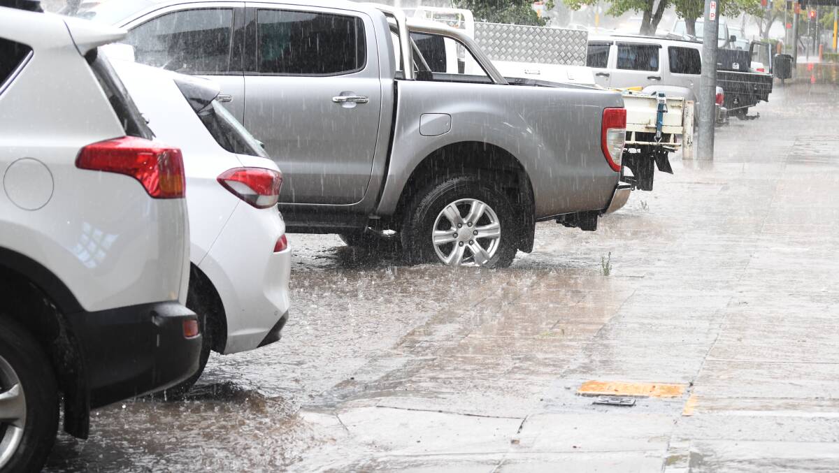 POOLING: Rain can't escape the gutters in Lords Place after a strong downpour on Thursday afternoon. Photo: JUDE KEOGH