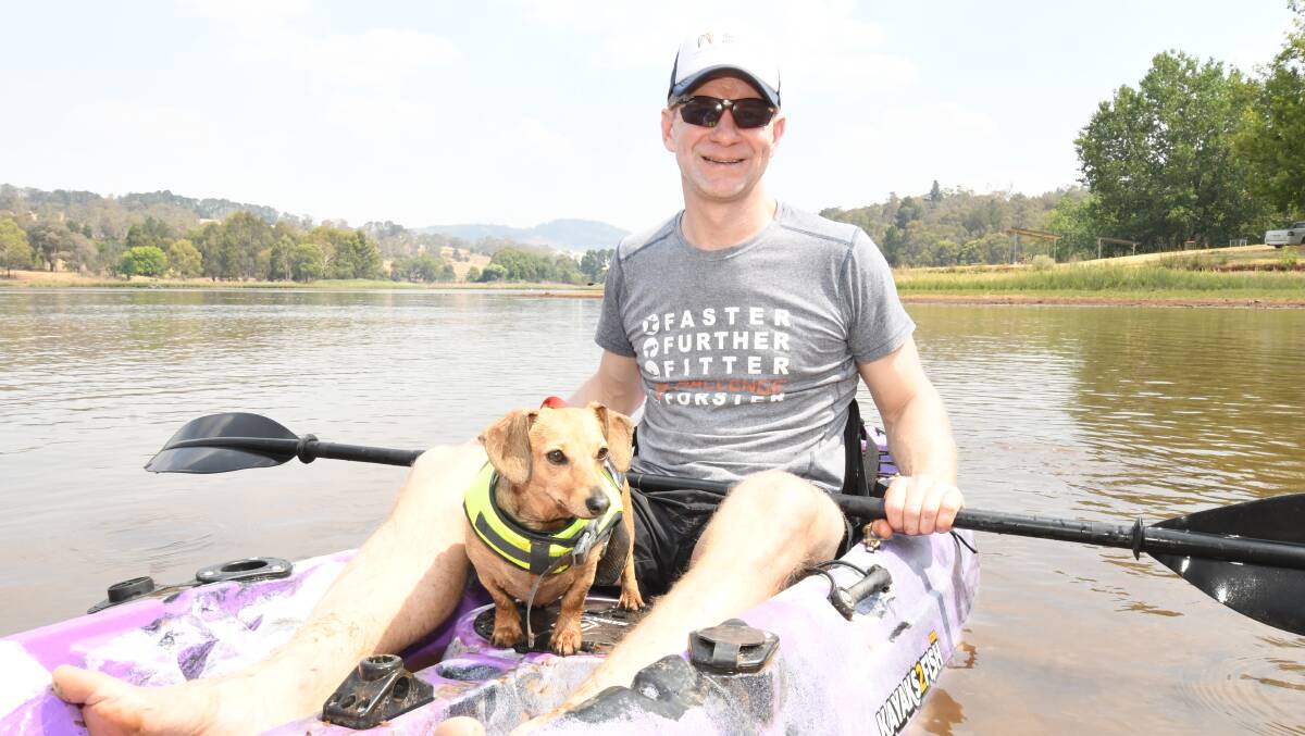 BEAT THE HEAT: Mick Lockyer and his dog Maggie beat the heat on Boxing Day with a canoe out at Lake Canobolas. Photo: JUDE KEOGH
