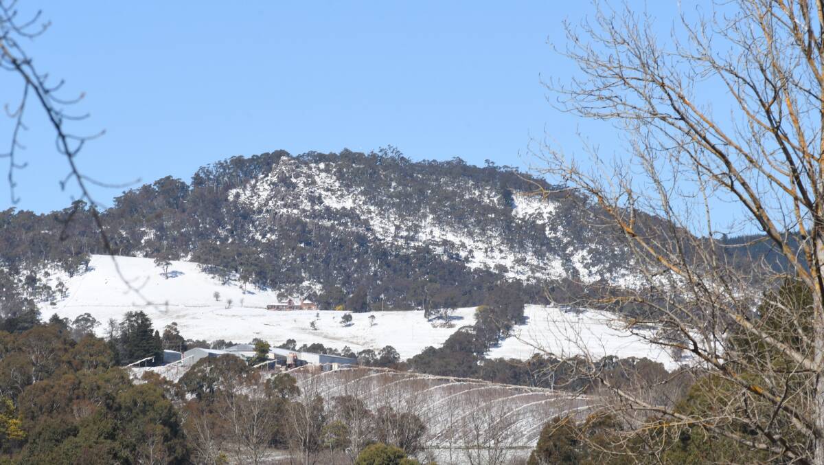 SNOW GO: Mount Canobolas' roads remain closed following snow on Sunday night and icy conditions on Monday. Pictured is the snowfall from August's heavy dump. Photo: CARLA FREEDMAN